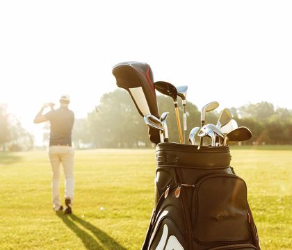 back-view-male-golfer-swinging-golf-club